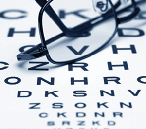 black and white eye chart and pair of rimmed glasses