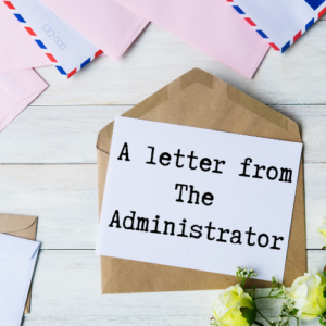 Note card and envelopes sitting on desk, note card reads Letter From The Administrator